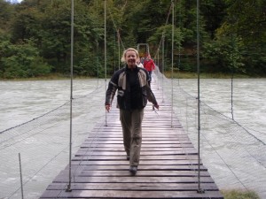 Lisa crossing a cable bridge going out to the Lago Grey Glaciar Grey viewing.